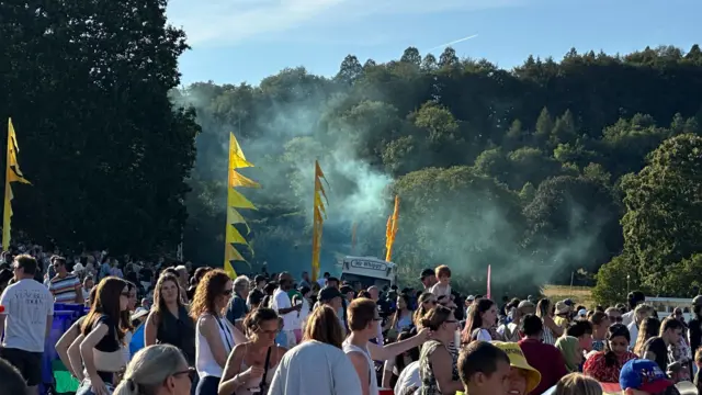 Green smoke above a crowd of people