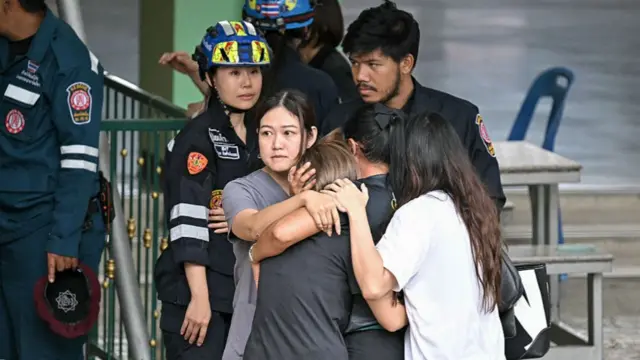 A group of people hugging one another
