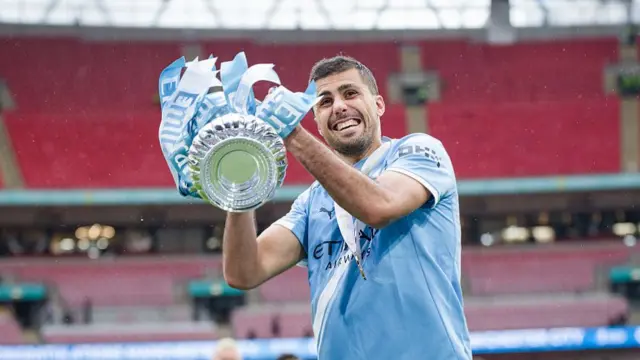 Rodri of Manchester City celebrates with the trophy after the Emirates FA Cup Final