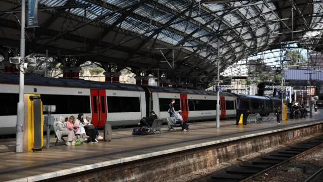 Commuters wait on a platform at Lime Street railway station in Liverpool, Britain, 06 August 2026