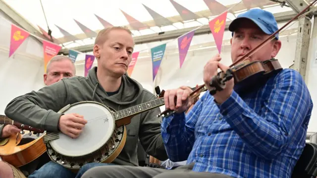 Three men playing instruments