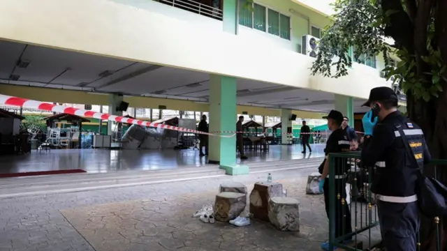 Police surround a cordoned area in the school