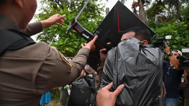 Officer carries a computer monitor