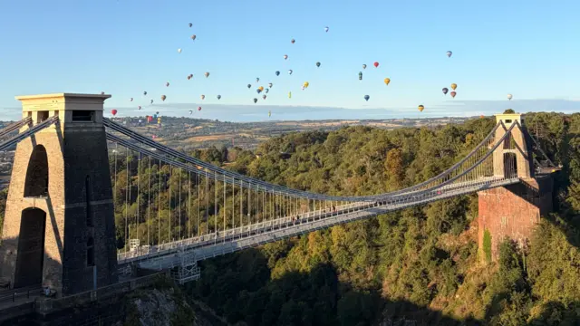 Balloons flying past the Clifton Suspension Bridge