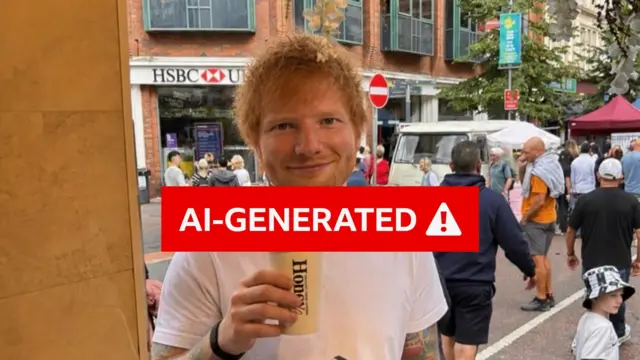 The image is covered with a red warning saying "AI-GENERATED" in the background there is a man with a white tee shirt and ginger hair, he is standing in a busy city centre with shops and people in the background. He is holding a brown coffee cup with black writing on it saying "Honey".