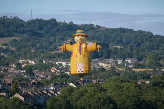 A huge inflated yellow scarecrow looms over houses and parkland in south Bristol.