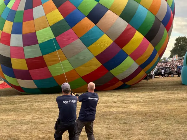 Two men working to inflate a hot air balloon