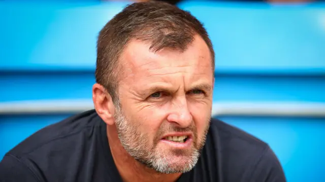 Charlton boss Nathan Jones sat down looking on from the bench