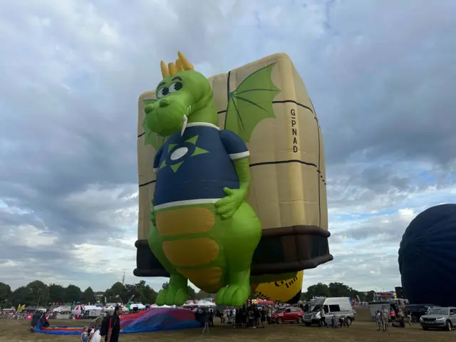 A hot air balloon with a green dragon on it