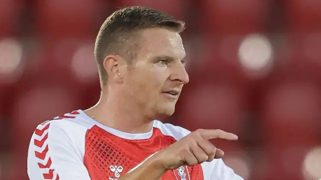 Rotherham striker Paul Mullin pointing towards a team-mate with his right hand