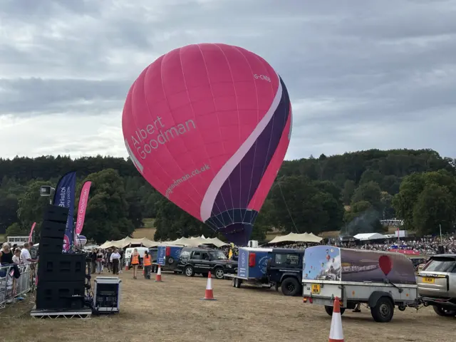 A pink hot air balloon being inflated