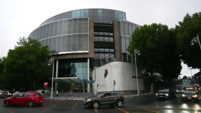 Dublin's Criminal Courts of Justice complex, seen with cars in front