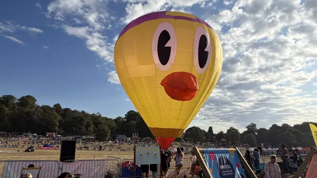 A yellow balloon shaped like a duck.