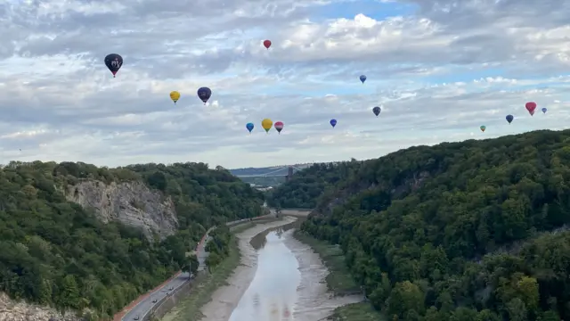 A view over the River Avon with balloons in the sky