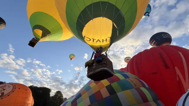 A balloon going up with people in the basket.