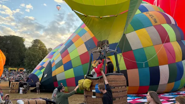People in a balloon basket.
