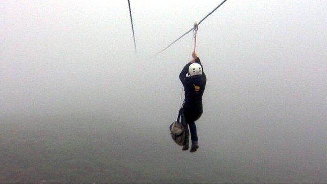 Woman goes on a zip wire slide