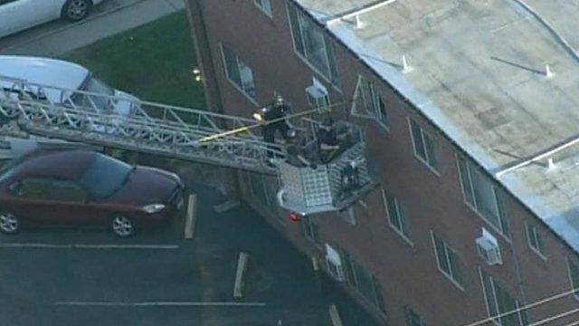 Police attempt to break into the suspect's apartment