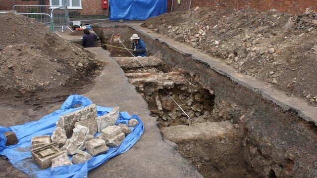 Archaeologists recording the grave