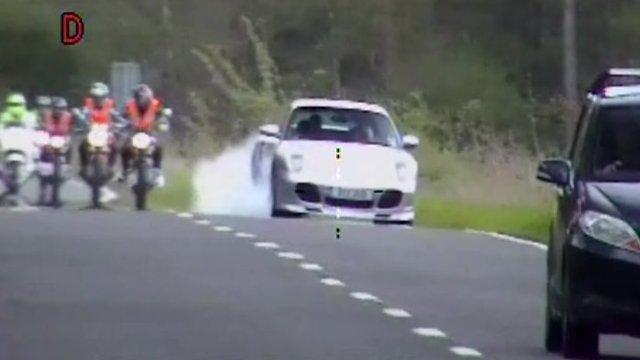 Porsche overtaking a line of motorbikes