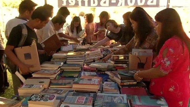 People looking at books on a table