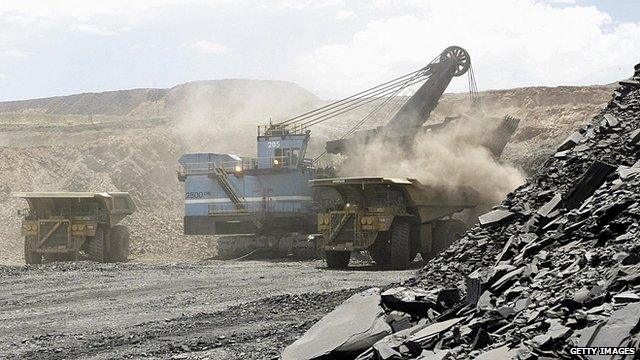 A hydraulic shovel loads a truck at an open cast diamond mine in Botswana