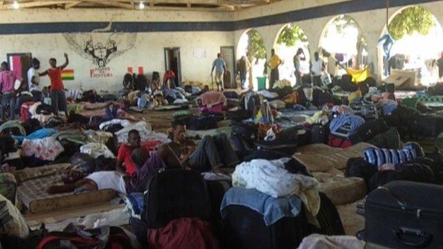 People waiting in a shelter at Brasileia