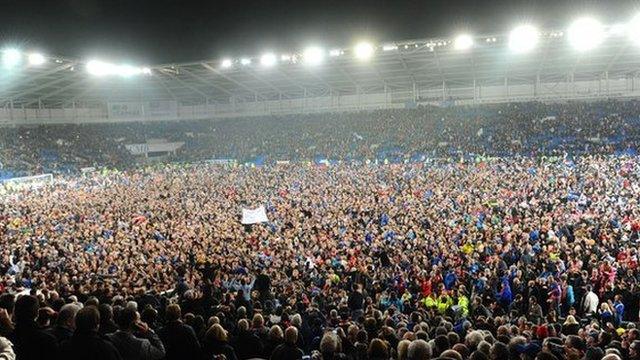 Fans celebrate Cardiff City's promotion after the draw with Charlton