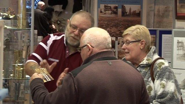 People looking at artefacts inside the WWII shop in Hull