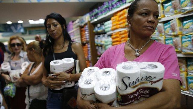 Women queuing to pay for toilet paper at a supermarket in Caracas