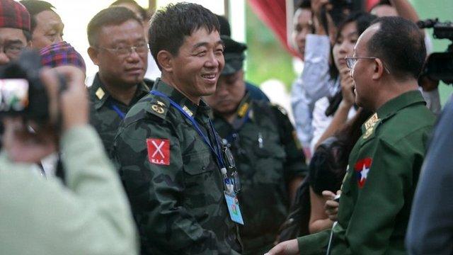 Deputy commander-in-chief of the Kachin Independence Army (KIA), Maj-Gen Guam Maw (left), shakes hands with a senior Burma official as they meet for talks in Myitkyina, Kachin state, 28 May 2013