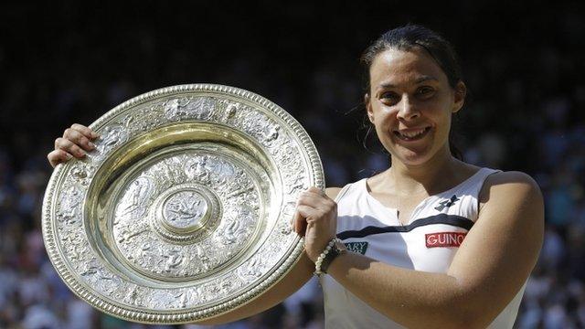 Marion Bartoli of France smiles as she holds the trophy after winning the Women's singles final match