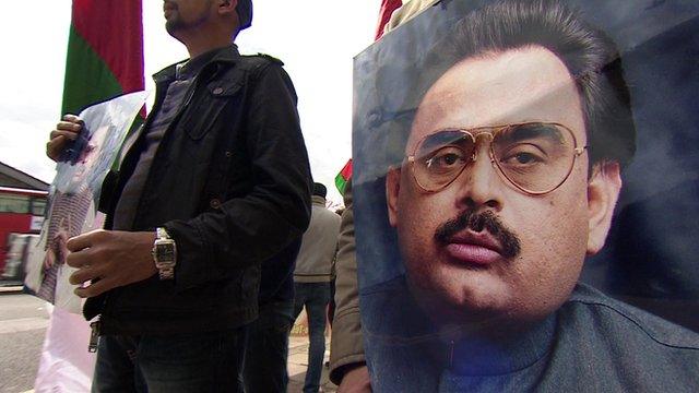 Man holding Altaf Hussain poster