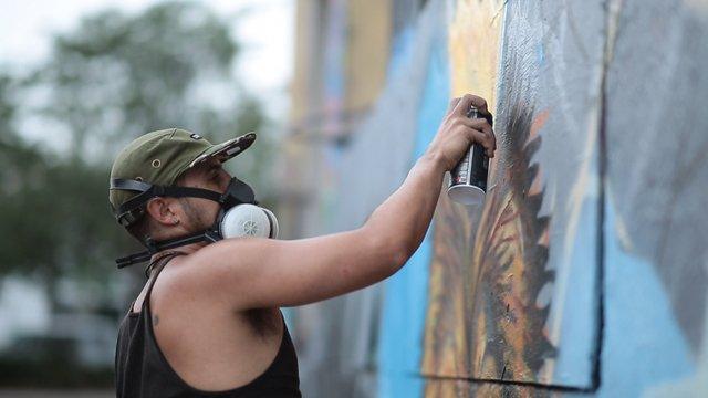 A graffiti artist spraying paint