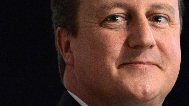 Britain"s Prime Minister David Cameron listens to speeches on the first day of the Conservative Party annual conference in Manchester northern England