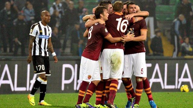 Roma players celebrate scoring at Udinese