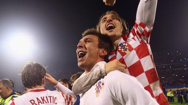 Croatia's Luka Modric (top) celebrates with goalscorer Mario Mandzukic