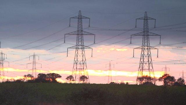 Sun sets behind electricity pylons