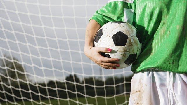 Goalkeeper holding a football