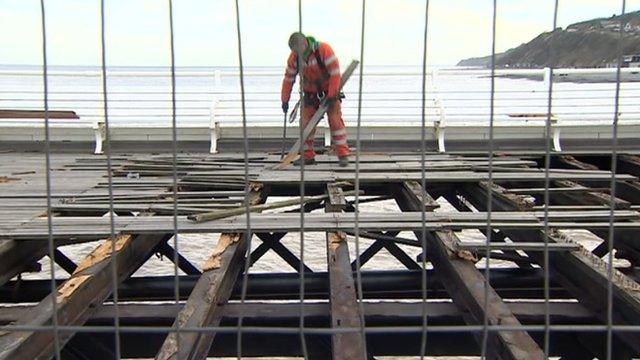 Workman repairing Cromer Pier