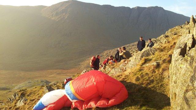 Rescuers help the paraglider