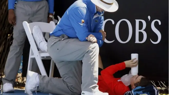 An official attends to a ball boy