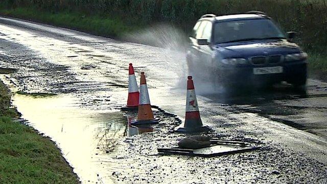 Car going through pothole