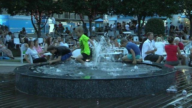 Children play in a water fountain in Melbourne Park