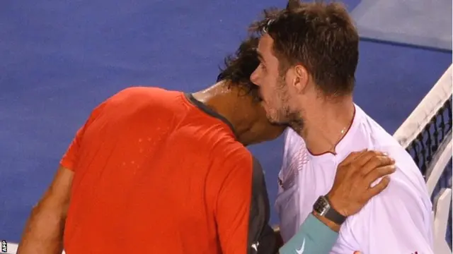 The players hug at the net