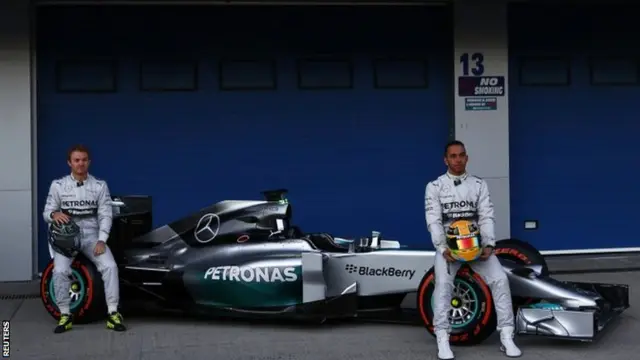 Nico Rosberg and Lewis Hamilton pose with the new Mercedes F1 W05 car