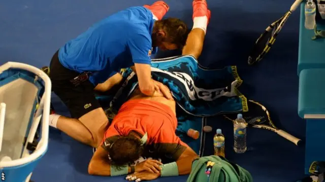 Rafael Nadal gets treatment for a back injury during the Australian Open final