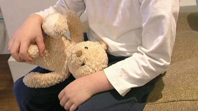 Child holding a teddy