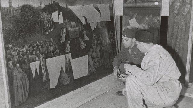 Lt. Daniel J. Kern and Karl Sieber examining the Ghent Altarpiece in the Altaussee mine, 1945