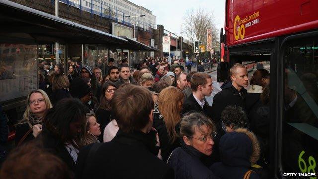 Passengers waiting to get on a bus